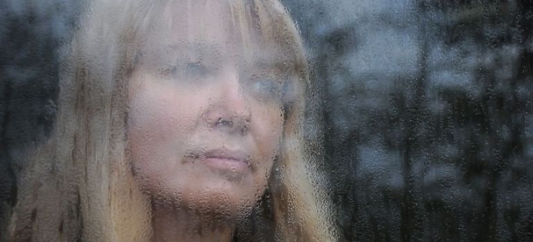 Woman looking out of window
