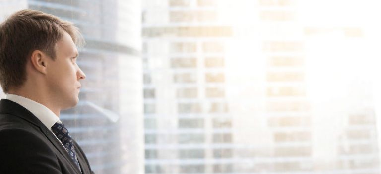 Business man looking out window