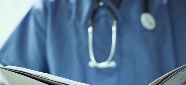 Doctor looking at notes