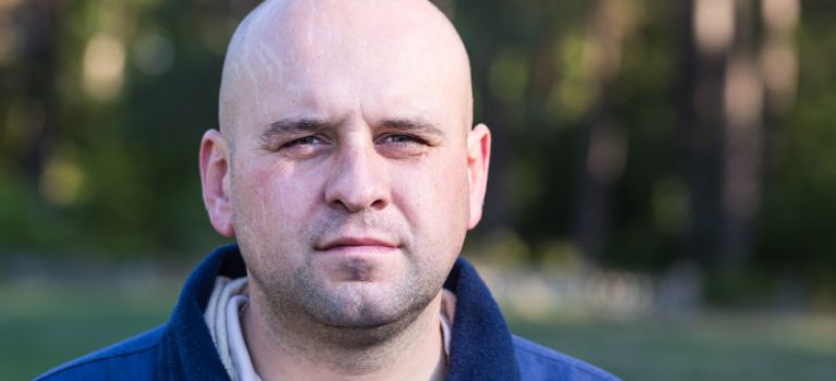 Man looking to camera in park