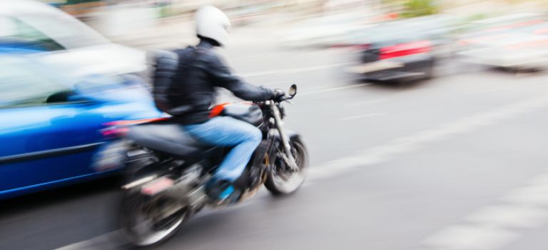 Motorcycle in traffic in town