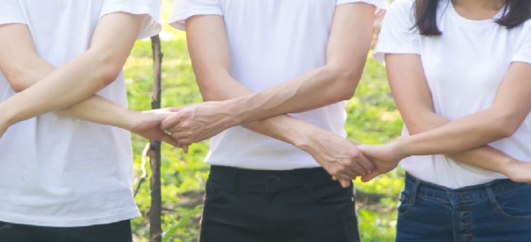 People with arms linked