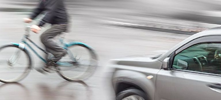 Cycling in front of car