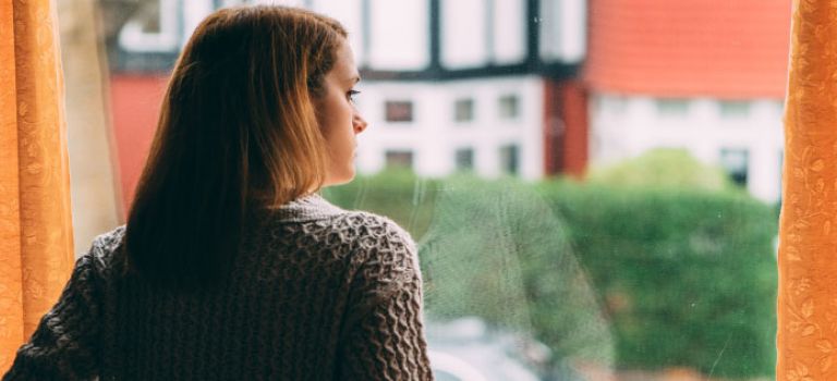 Woman looking out her window