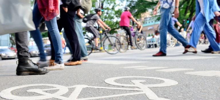 Padestrians crossing road with cyclists in background