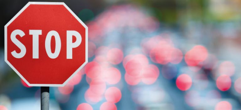 Stop road sign in traffic