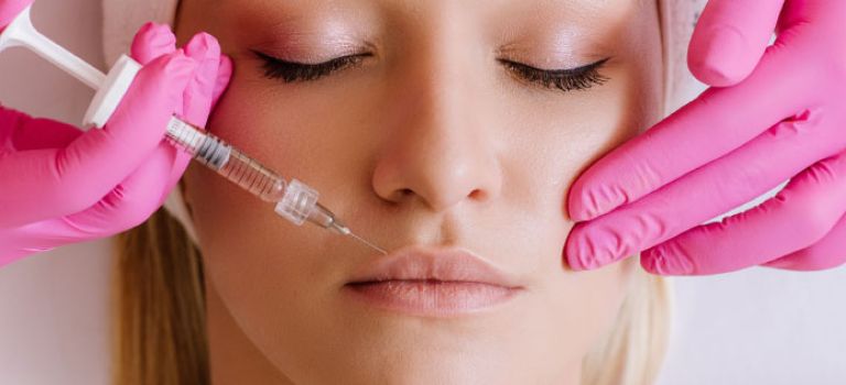Woman getting lip filler procedure