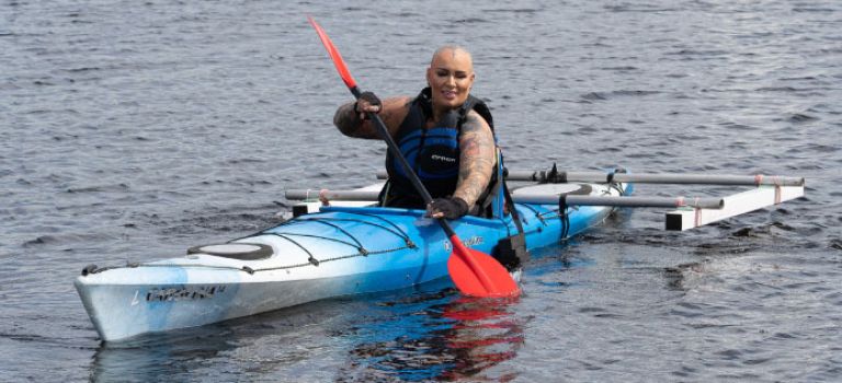 Woman using adapted kayak at Castle Semple