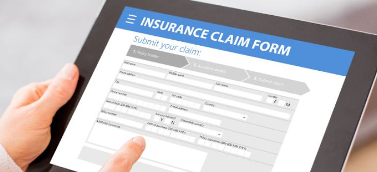 Filling out car insurance claim form