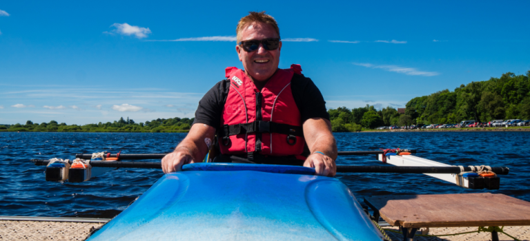 A male wheelchair user pictures in an adaptable kayak 