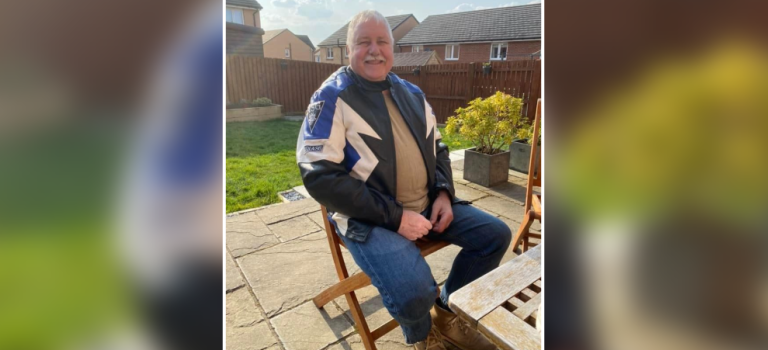 James Cochrane pictured sitting on a chair in a sunny garden