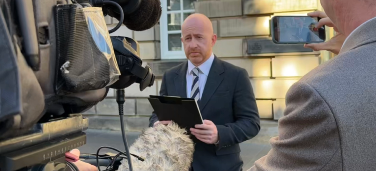 Ryan Smith, Partner in our Kirkcaldy office, pictured reading a statement to media outside the High Court in Edinburgh