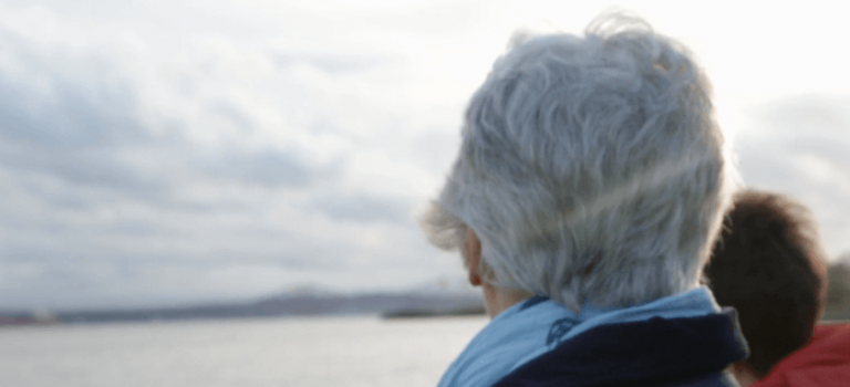 Older woman looking out to sea