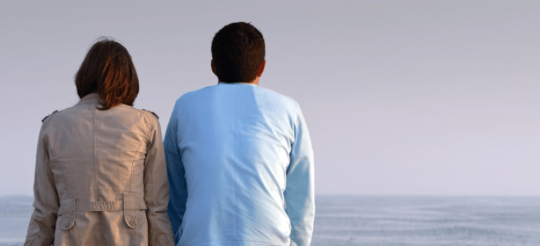 Couple sitting looking out to sea