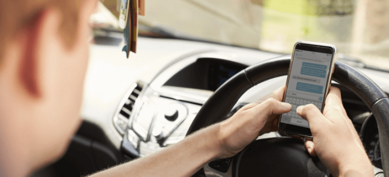 Driver texting on mobile phone whilst driving