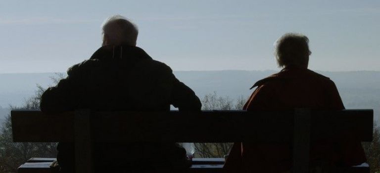 Elderly couple sitting on bench