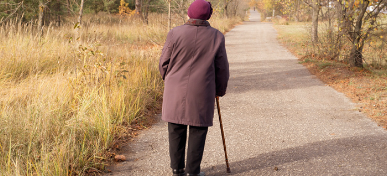 Old woman walking with stick