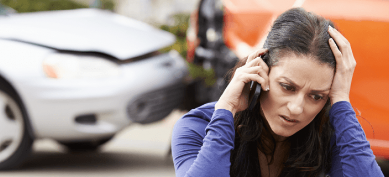 Woman on phone after road crash