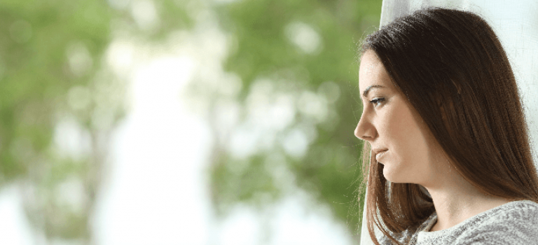 Woman Looking Out Window
